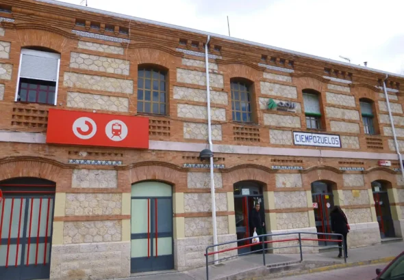 Fachada de ladrillo visto y piedra de la estación de tren de Cercanías de Ciempozuelos, con los carteles identificativos de Adif y Cercanías, y una rampa de acceso en la entrada.